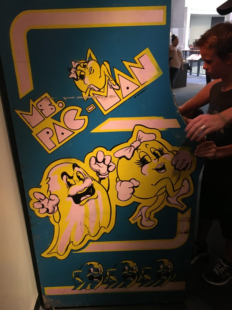 side of old blue and yellow arcade game Ms Pac Man, faded