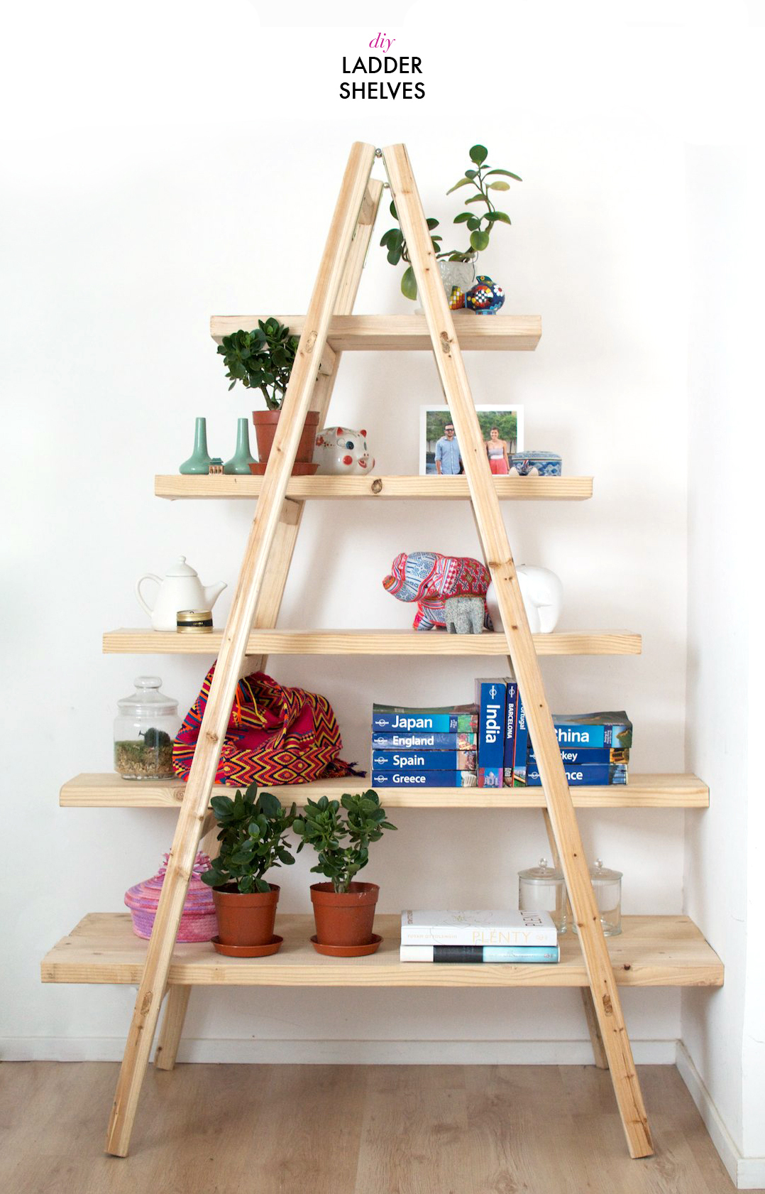 A ladder upcycled into shelves, covered with books and plants and knick knacks. 
