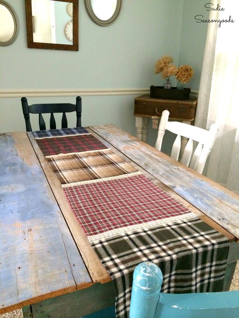 A plaid and checkered table runner stretches across a table. 