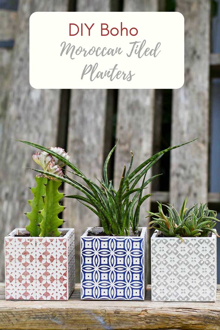 Three square tile planters hold succulents.