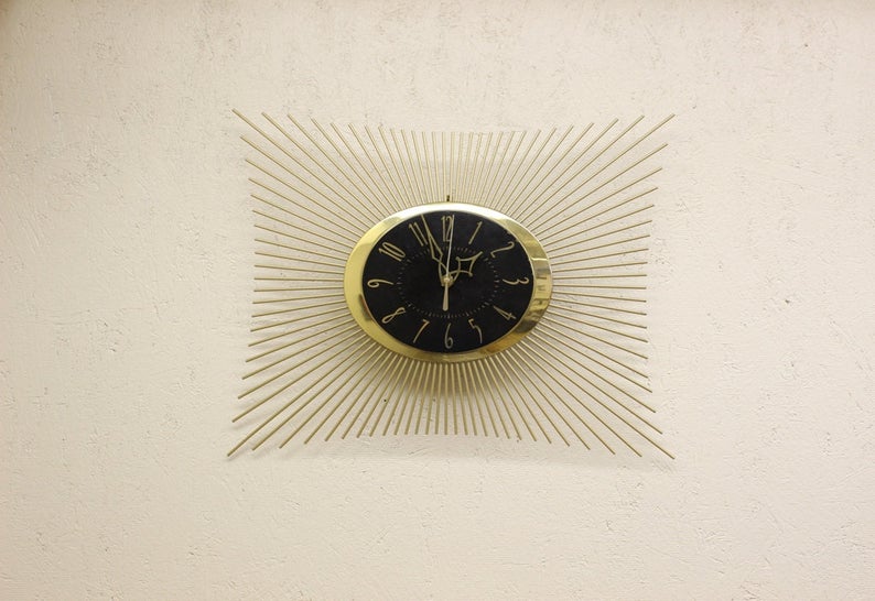 black and gold starburst wall clock