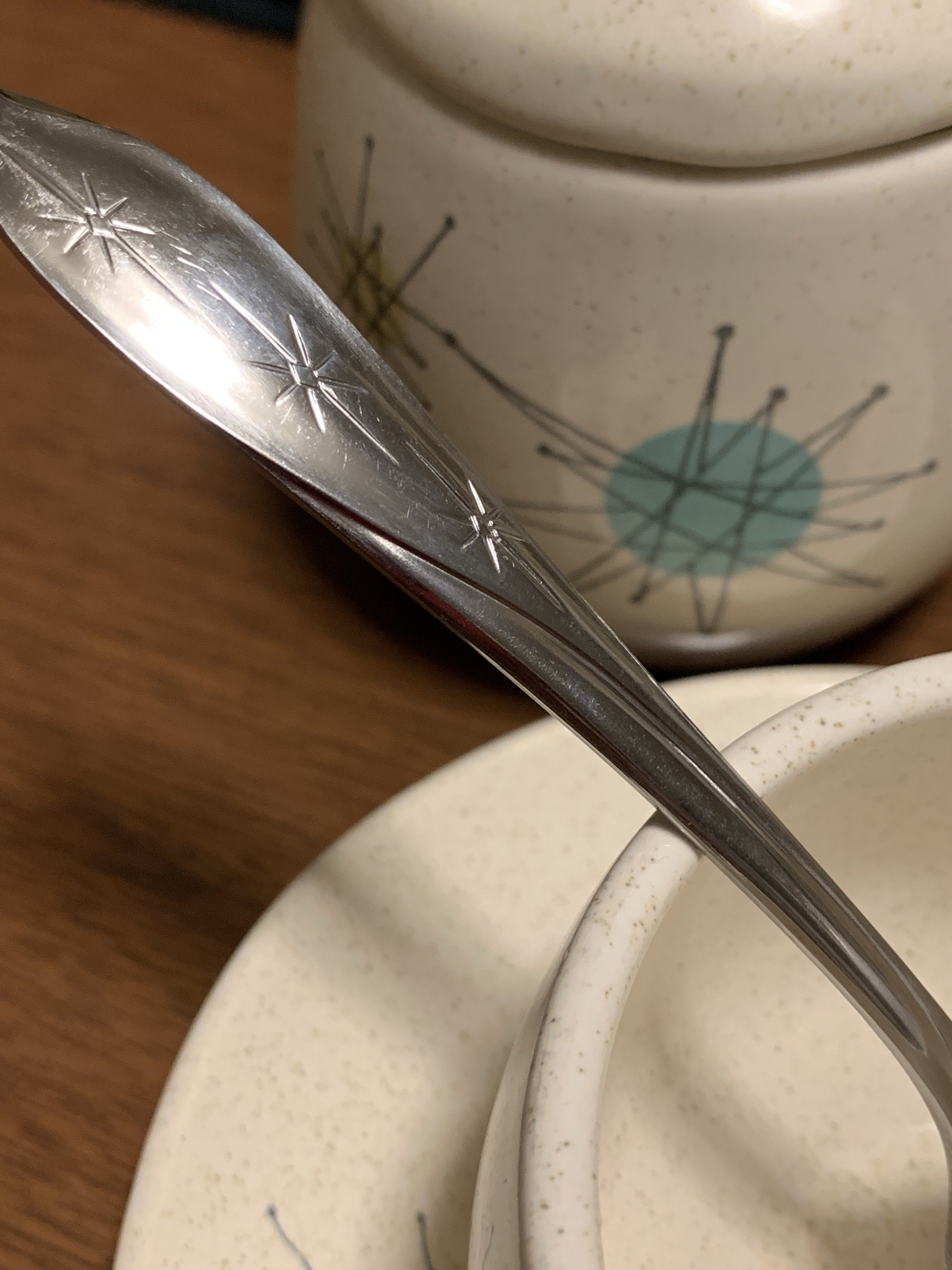 Silver flatware with star pattern.