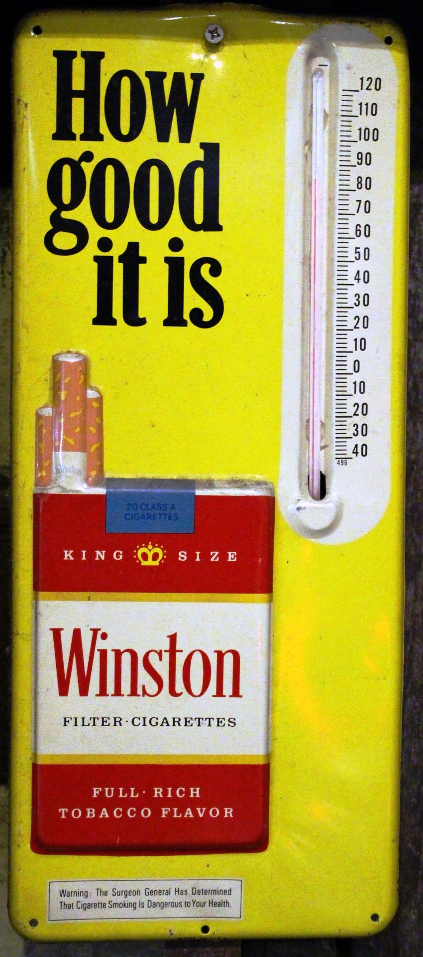 Metal sign advertising Winston cigarettes with a thermometer attached.