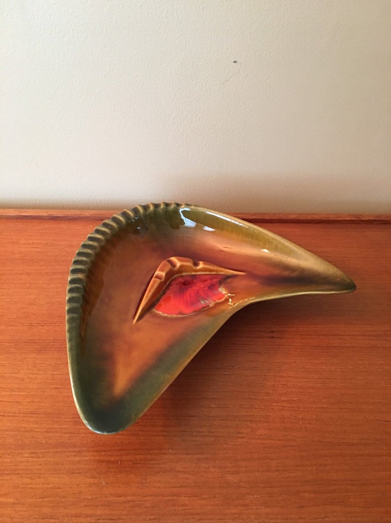 Brown green and orange boomerang ashtray.