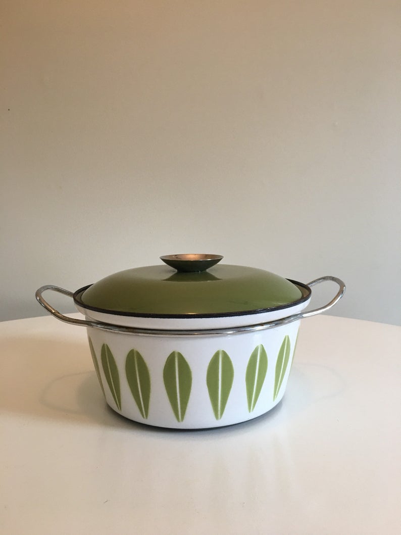 White and green enamel pot with green lid.