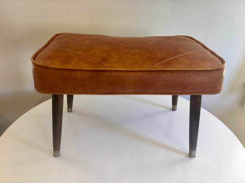 Brown leather ottoman.