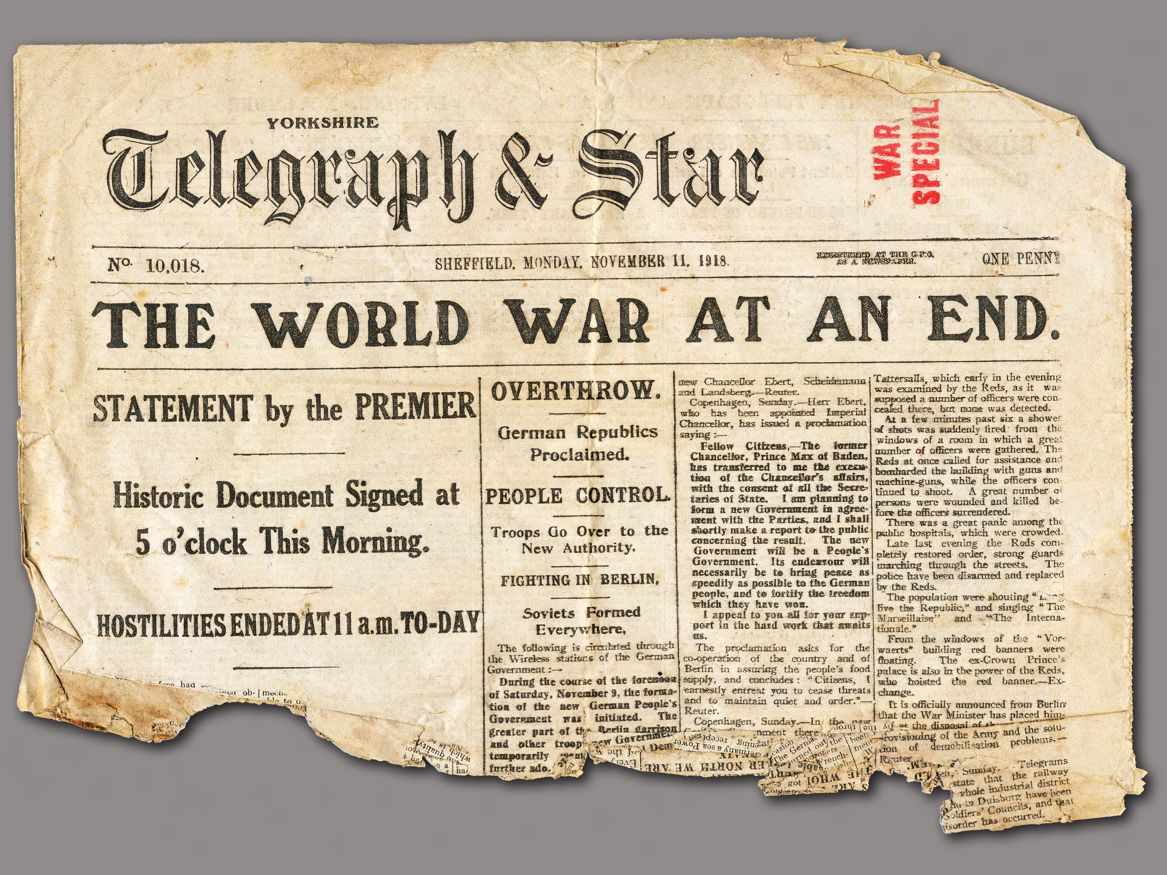 Newspaper headline reads "The World War At An End." 